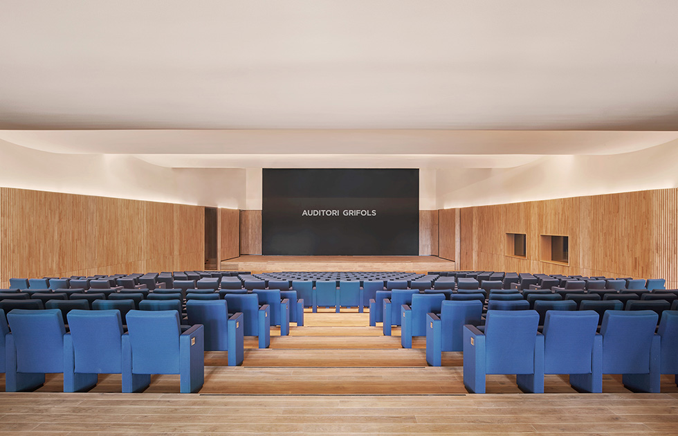 View of the auditorium, featuring tiered seating and warm wooden accents designed for optimal acoustics and comfort.